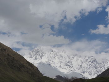 Scenic view of snowcapped mountains against sky