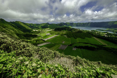 Scenic view of mountain and sea against sky