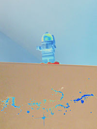 Low angle view of painting on wall against clear blue sky