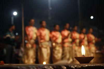 Illuminated candles burning at night