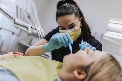 Female dentist with patient in dentist's office