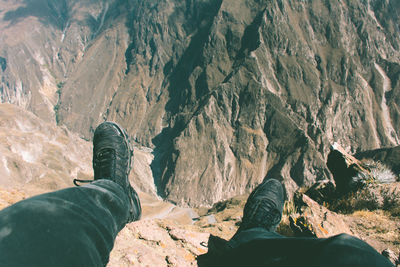 Low section of person standing on rock