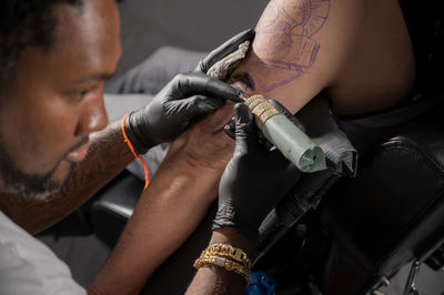 Cropped image of man repairing car