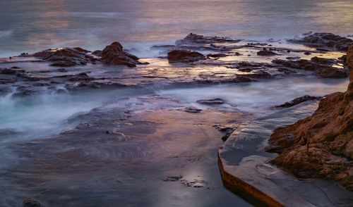 High angle view of rocks on beach against sky