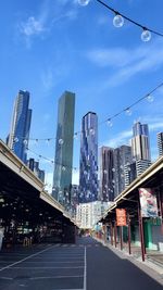 City street and buildings against sky