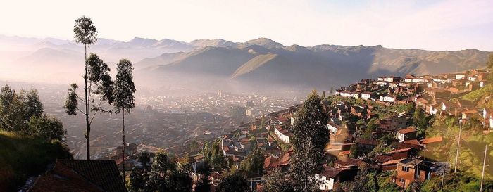 Panoramic view of cityscape and mountains against sky