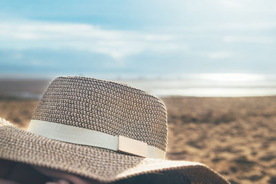 Close-up of hooded chair on beach