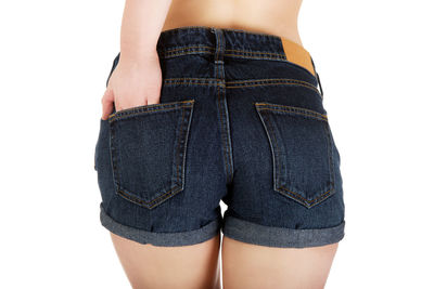 Midsection of woman standing against white background