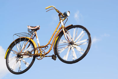 Low angle view of bicycle against clear blue sky