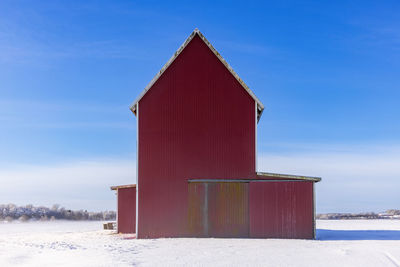 Red barn on snowy field