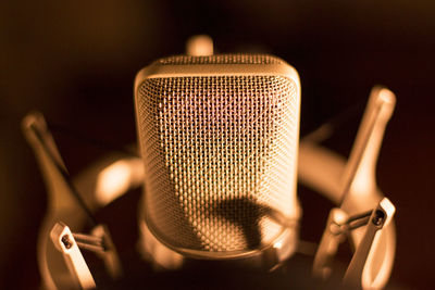 Close-up of microphone against black background