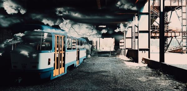 Train at railroad station platform against sky