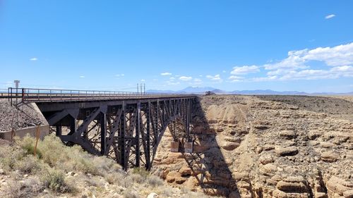 Arch bridge over land against sky