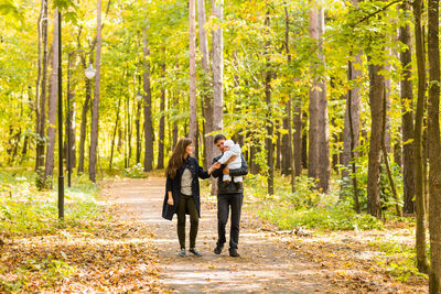 Man and woman standing in forest