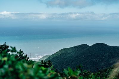 Scenic view of sea and mountains against sky