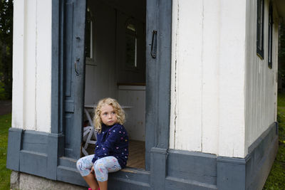 Portrait of girl in front of building