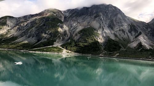 Scenic view of lake and mountains against sky