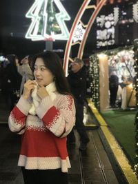 Full length of woman looking away at night