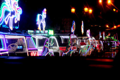 Illuminated amusement park ride at night