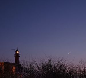 Lighthouse against sky at night