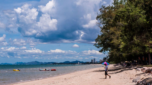 People on beach against sky