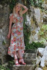 Midsection of woman standing against plants