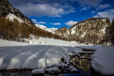 Scenic view of snow covered mountains against sky