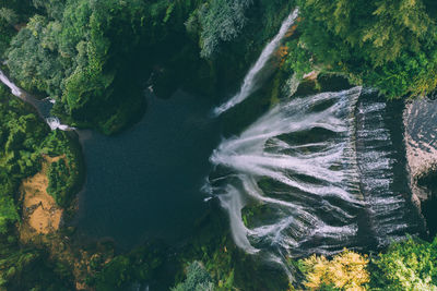 Big waterfall. top view of water drop from drone. artificial waterfall in italy
