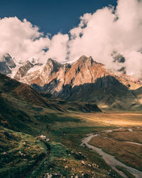 Scenic view of mountains against cloudy sky