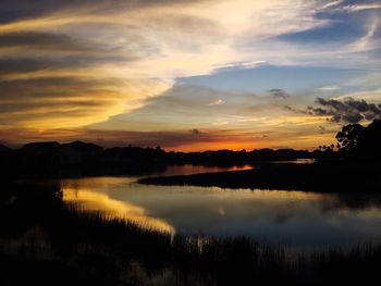 Scenic view of lake at sunset