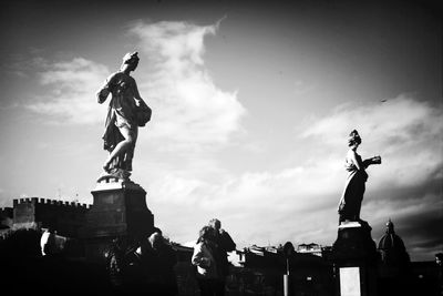 Low angle view of statue against cloudy sky