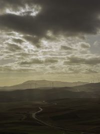 Road by landscape against sky