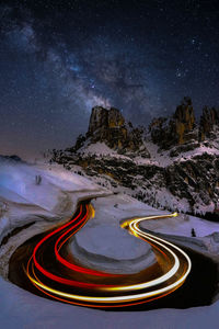 High angle view of light trails on road against sky at night