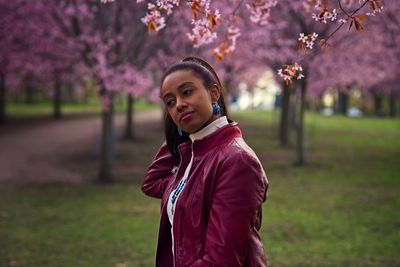 Portrait of beautiful young woman standing in park