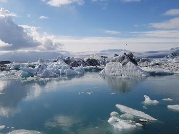 Scenic view of frozen lake against sky