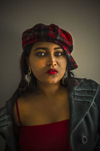 Portrait of young woman wearing hat