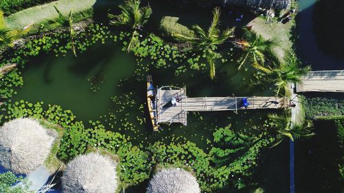 Drone shot of woman lying on pier over lake