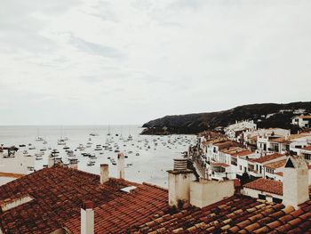 Townscape by sea against sky