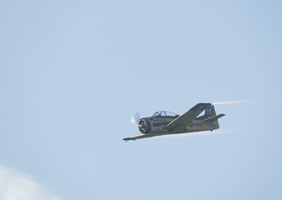 Low angle view of airplane flying against clear sky