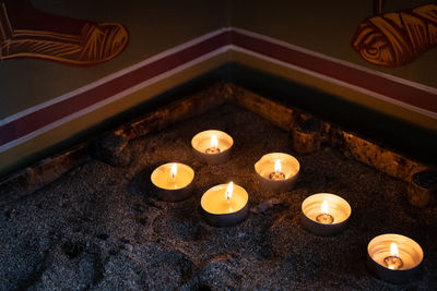 Church candles glowing with orange flames in a temple. symbols of faith and religion 