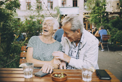 Rear view of man and woman on table