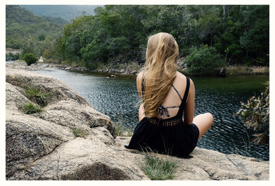 Rear view of woman in hat against trees