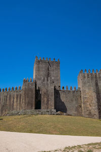 Low angle view of fort against blue sky