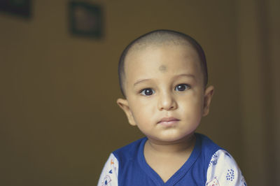 Close-up portrait of cute baby boy at home