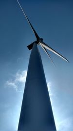 Low angle view of traditional windmill against blue sky