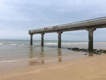 Bridge over sea against sky