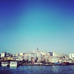 View of cityscape against clear blue sky