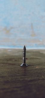 Close-up of chain on table by sea