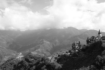 Scenic view of mountains against cloudy sky