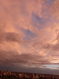 Aerial view of city buildings against sky during sunset